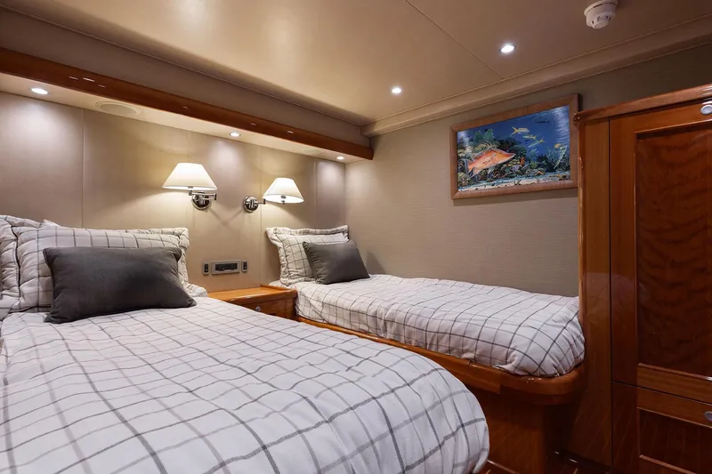 Slide: The Image of Luxurious twin cabin interior on 2016 Viking 82 Sky Bridge yacht, featuring elegant bedding and decor. - 23