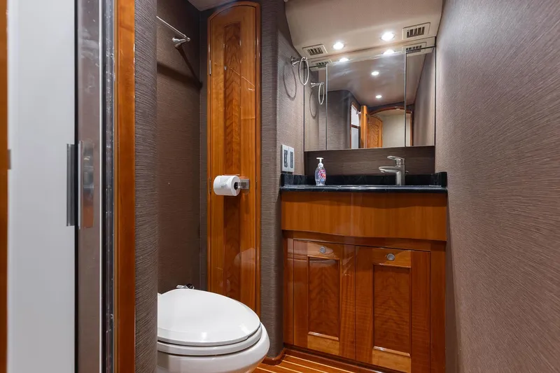 Slide: The Image of Luxurious bathroom interior of 2016 Viking 82 Sky Bridge yacht with wood accents. - 24