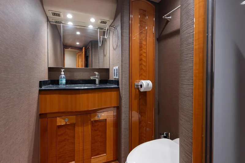 Slide: The Image of Luxurious bathroom interior of 2016 Viking 82 Sky Bridge yacht with wood accents and modern fixtures. - 26