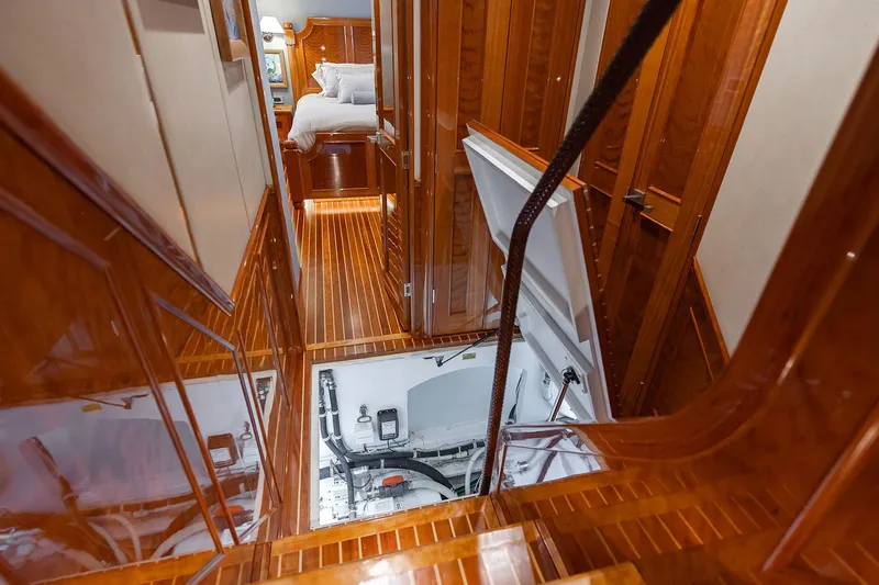 Slide: The Image of Luxurious interior of 2016 Viking 82 Sky Bridge yacht with wooden flooring and open hatch. - 27