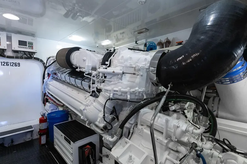 Slide: The Image of Engine room of a 2016 Viking 82 Sky Bridge yacht, showcasing a powerful engine setup. - 28