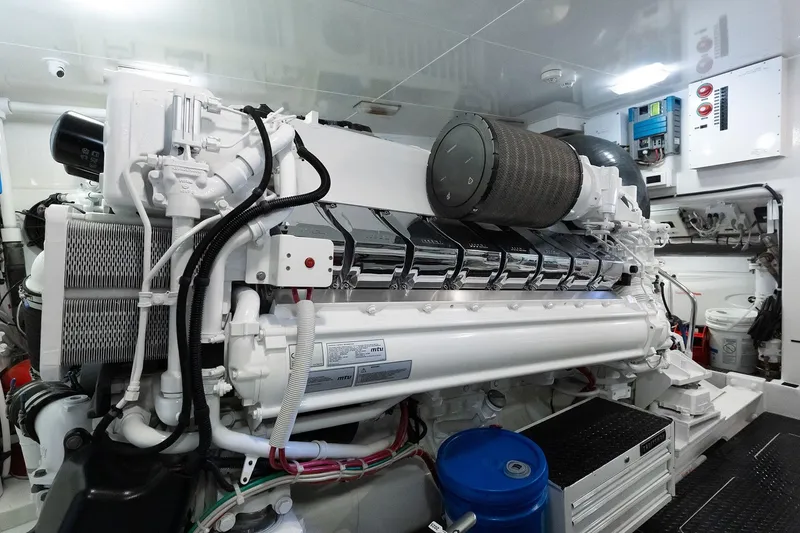 Slide: The Image of Engine room of a 2016 Viking 82 Sky Bridge yacht, showcasing a powerful marine engine. - 29