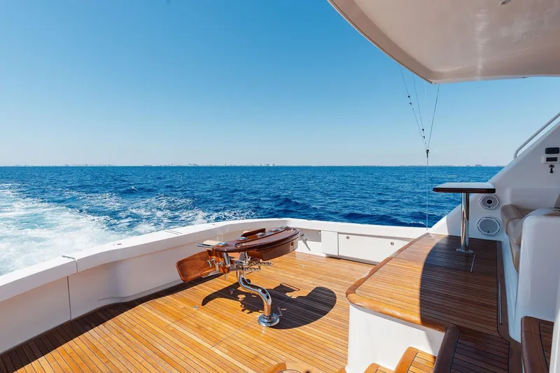 Slide: The Image of Luxurious 2016 Viking 82 Sky Bridge yacht deck with ocean view and wooden flooring. - 4