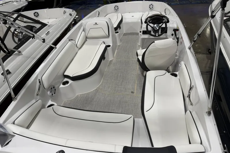 Slide: The Image of 2026 Stingray 182 SC boat interior with white seating and modern steering console. - 2