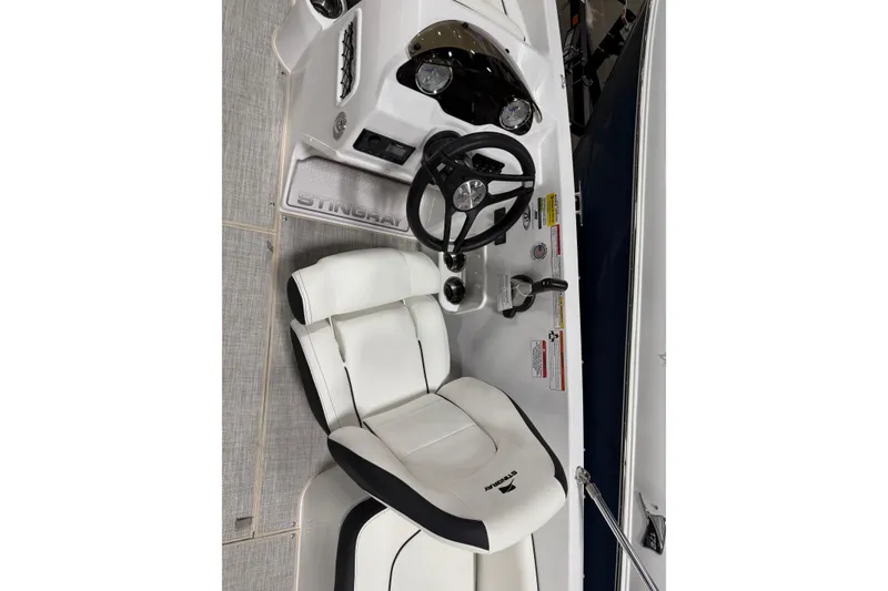 Slide: The Image of 2026 Stingray 182 SC boat cockpit with steering wheel and white seating. - 3