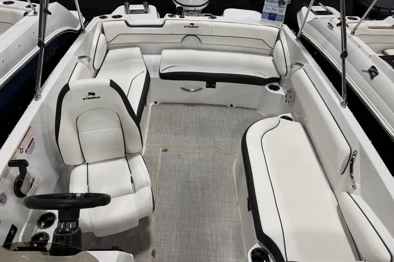Slide: The Image of 2026 Stingray 182 SC boat interior with white seating and steering wheel. - 5