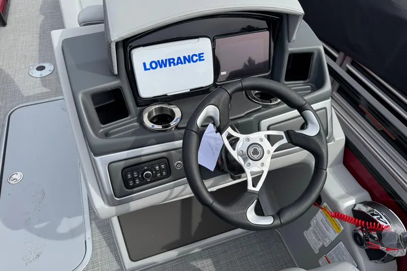 Slide: The Image of Steering console of 2025 Regency 230 DL3 boat with Lowrance display and controls. - 10