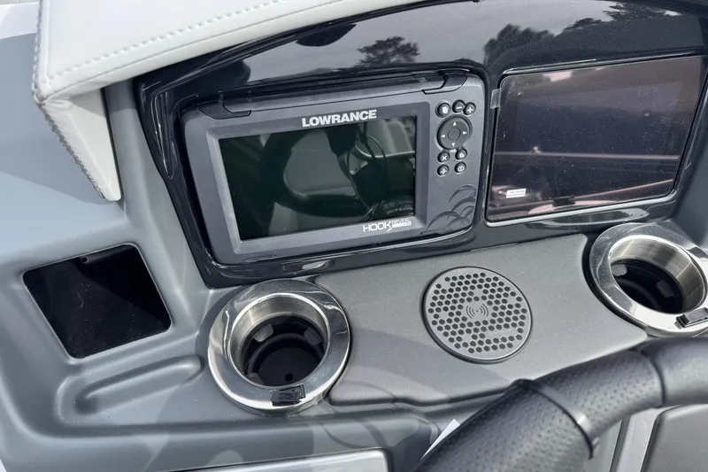 Slide: The Image of Dashboard of 2025 Regency 230 DL3 with Lowrance Hook display and cup holders. - 11