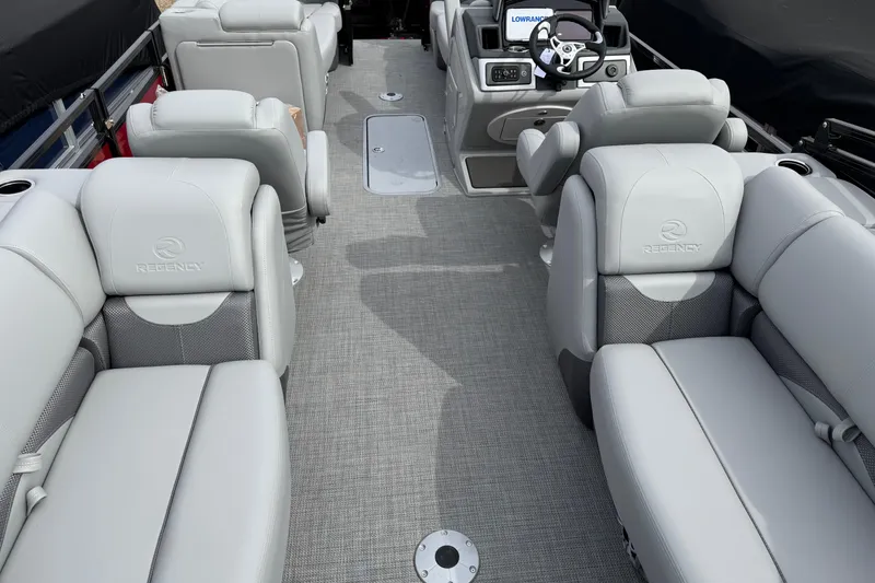 Slide: The Image of Luxurious interior of 2025 Regency 230 DL3 pontoon boat with plush seating and modern dashboard. - 15