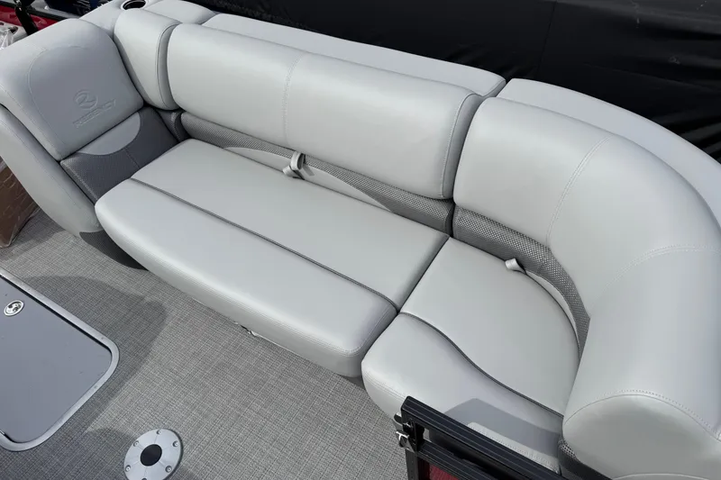 Slide: The Image of Luxurious seating on 2025 Regency 230 DL3 pontoon boat, featuring plush gray upholstery. - 7