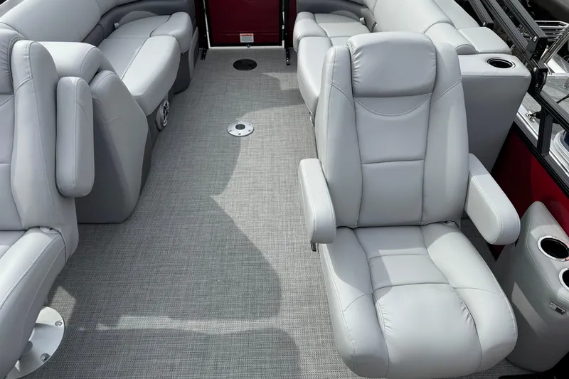 Slide: The Image of Luxurious seating on 2025 Regency 230 DL3 boat with gray upholstery and cup holders. - 8