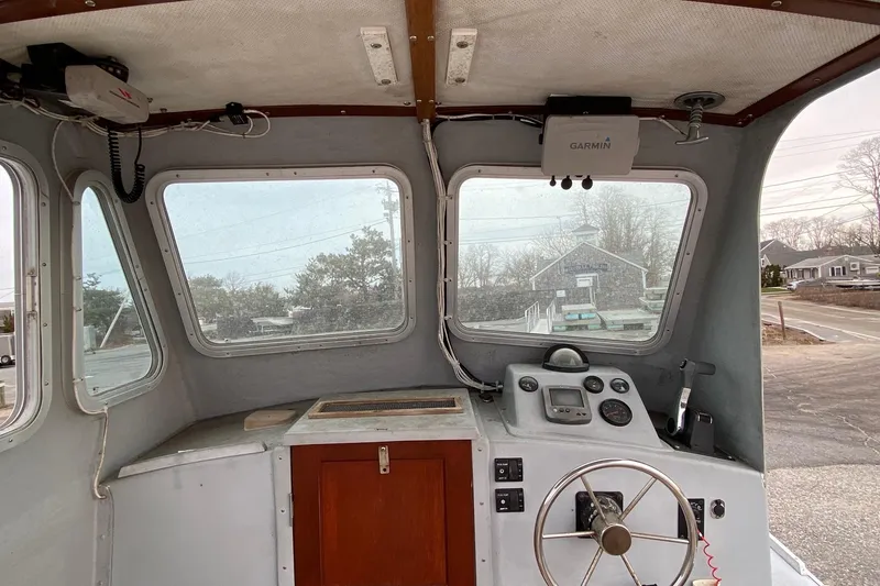 Slide: The Image of 1985 SISU Lobster Boat interior with steering wheel and navigation equipment. - 12