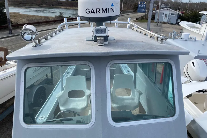 Slide: The Image of 1985 SISU Lobster Boat 22' with Garmin radar, docked at a marina. - 7