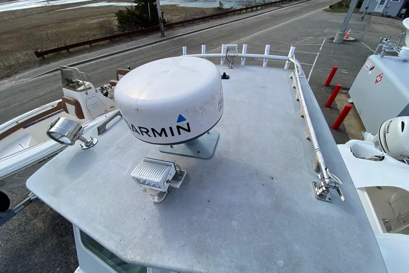 Slide: The Image of 1985 SISU Lobster Boat - 22' with Garmin radar on deck, docked near shoreline. - 8
