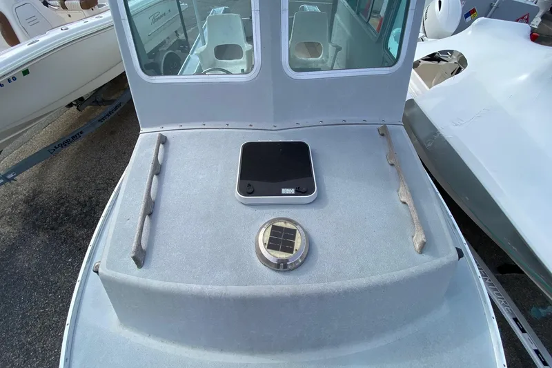 Slide: The Image of 1985 SISU Lobster Boat 22' deck with solar panel and hatch, docked. - 9