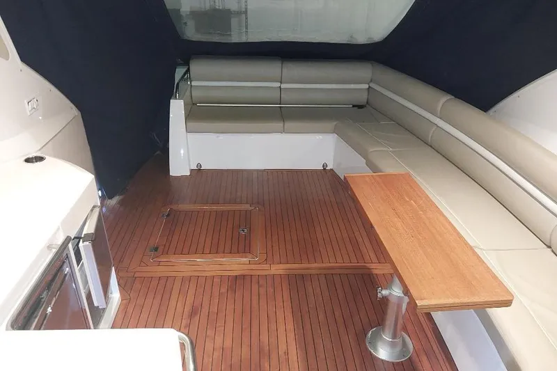 Slide: The Image of 2012 Sunseeker Portofino 48 yacht interior with wooden flooring and beige seating. - 6