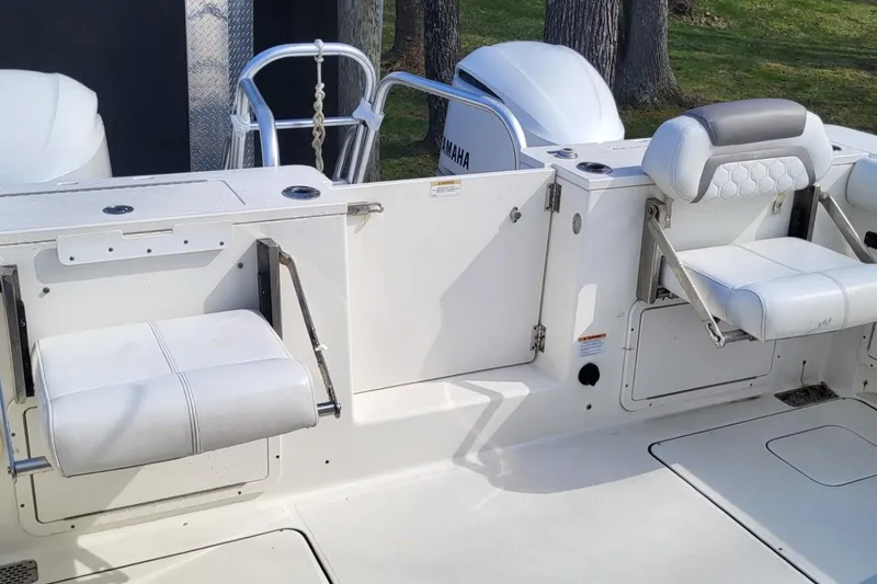 Slide: The Image of 2019 World Cat 320 CC boat interior with white seating and Yamaha engine. - 11
