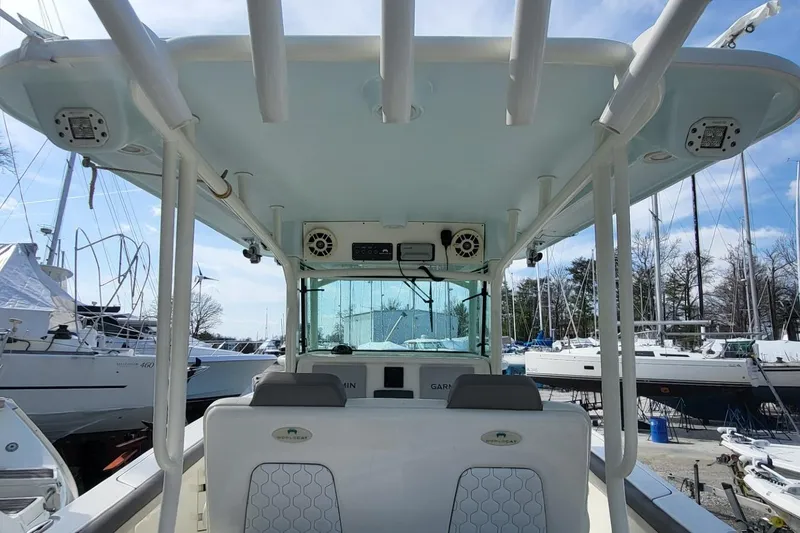 Slide: The Image of 2019 World Cat 320 CC boat interior with seating and overhead structure. - 13