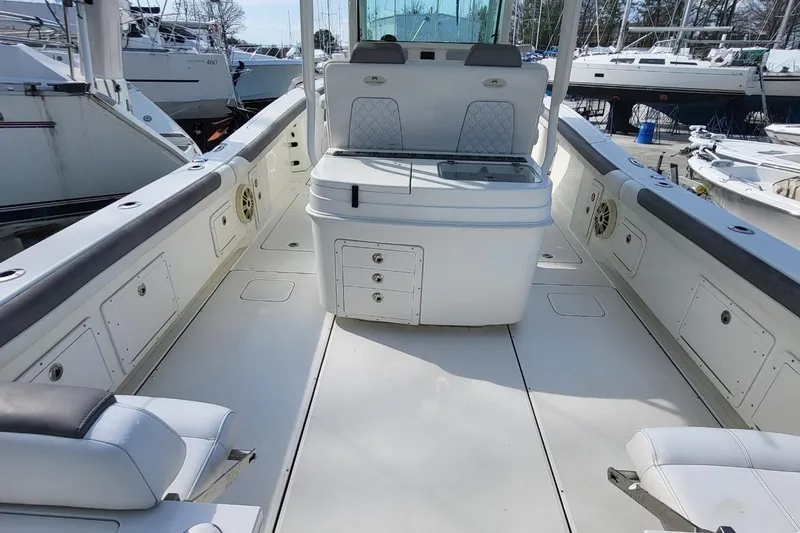 Slide: The Image of 2019 World Cat 320 CC boat interior with seating and storage compartments. - 14