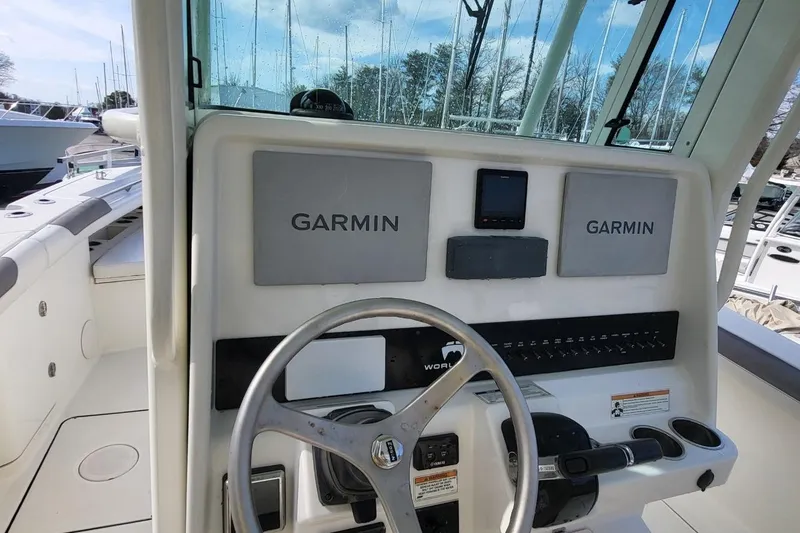 Slide: The Image of 2019 World Cat 320 CC boat dashboard with Garmin navigation system. - 18