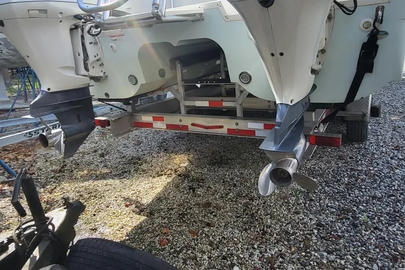 Slide: The Image of 2019 World Cat 320 CC boat on trailer, showing dual outboard motors. - 3