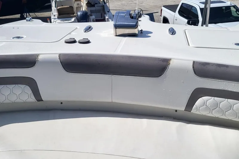 Slide: The Image of 2019 World Cat 320 CC boat interior with cushioned seating and deck details. - 6