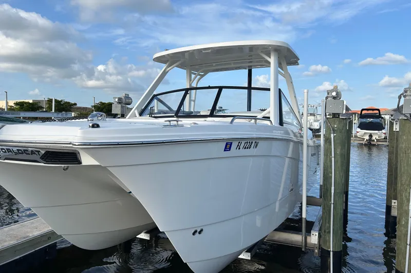 Slide: The Image of 2024 World Cat 260 DC-X boat docked at marina under blue sky. - 3