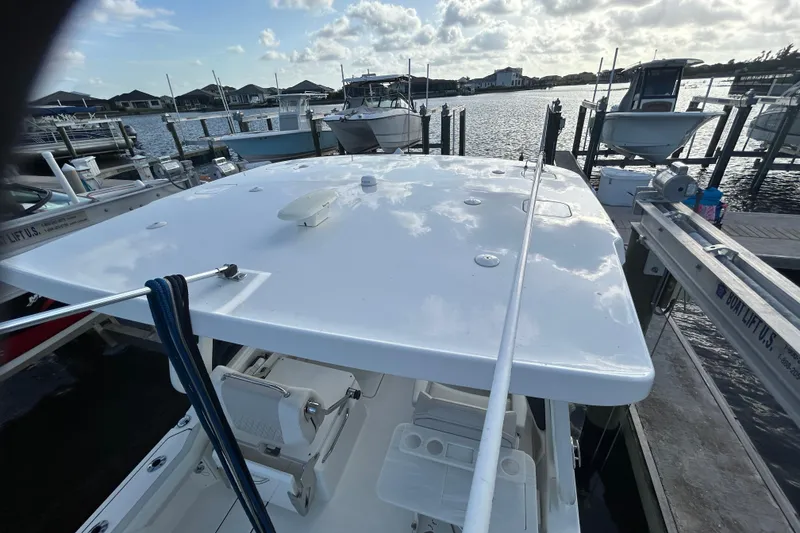 Slide: The Image of 2024 World Cat 260 DC-X boat docked at marina under cloudy sky. - 6