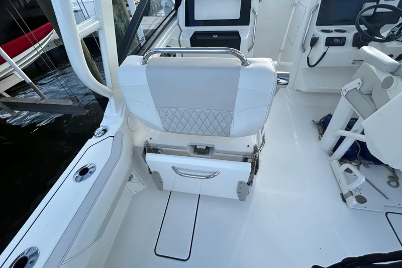Slide: The Image of 2024 World Cat 260 DC-X boat interior with white seating and modern controls. - 7