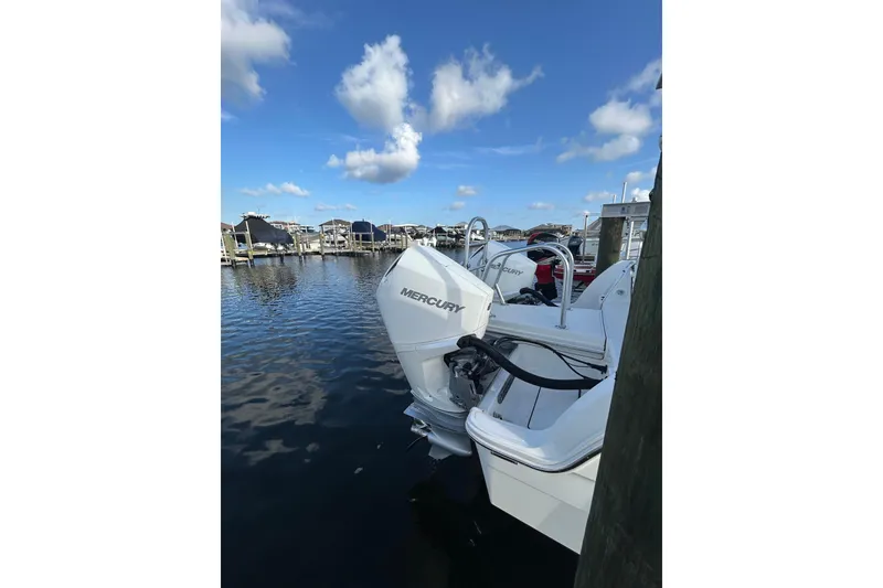 Slide: The Image of 2024 World Cat 260 DC-X boat with Mercury engines docked at marina. - 8