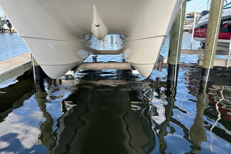 Slide: The Image of 2024 World Cat 260 DC-X catamaran hull in marina, reflecting on water. - 9