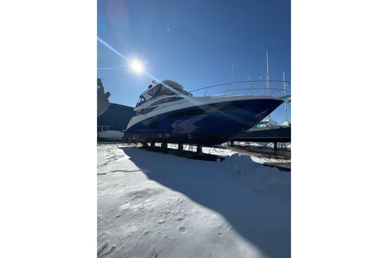 The Image of 2018 Sea Ray L590 Fly yacht on snowy ground under bright sun. - 0