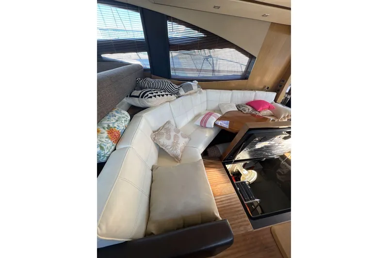 Slide: The Image of Interior of 2018 Sea Ray L590 Fly with white leather sofas. - 14
