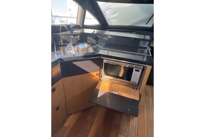 Slide: The Image of Luxurious 2018 Sea Ray L590 Fly yacht kitchen with modern appliances and sleek design. - 15