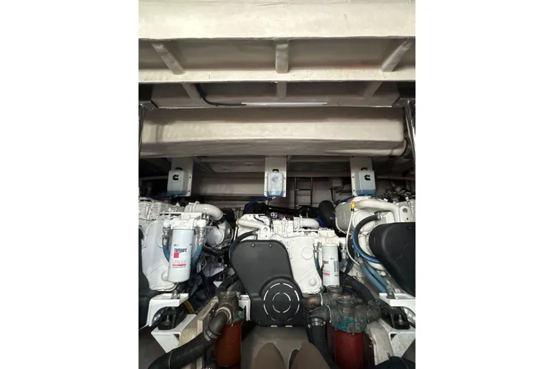 Slide: The Image of Engine room of 2018 Sea Ray L590 Fly yacht, showcasing dual engines and mechanical components. - 16