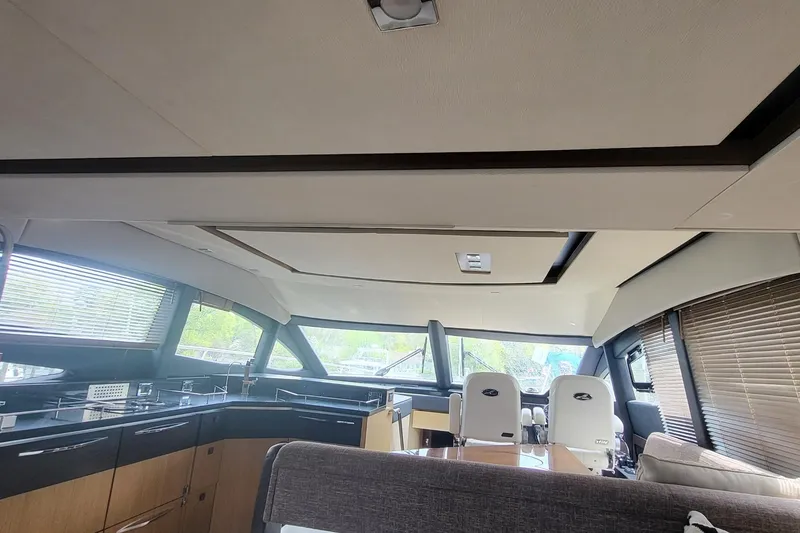 Slide: The Image of Interior of 2018 Sea Ray L590 Fly yacht with modern design and panoramic windows. - 23