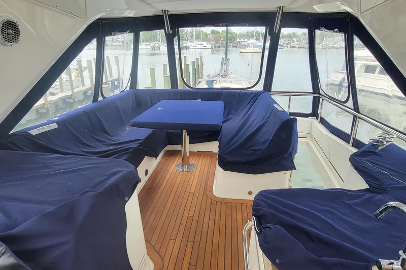 Slide: The Image of 2018 Sea Ray L590 Fly yacht interior with blue seating and wooden flooring. - 25