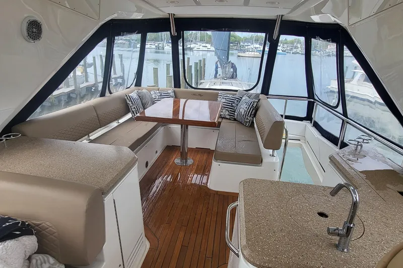 Slide: The Image of Luxurious interior of 2018 Sea Ray L590 Fly yacht with elegant seating and wooden flooring. - 26