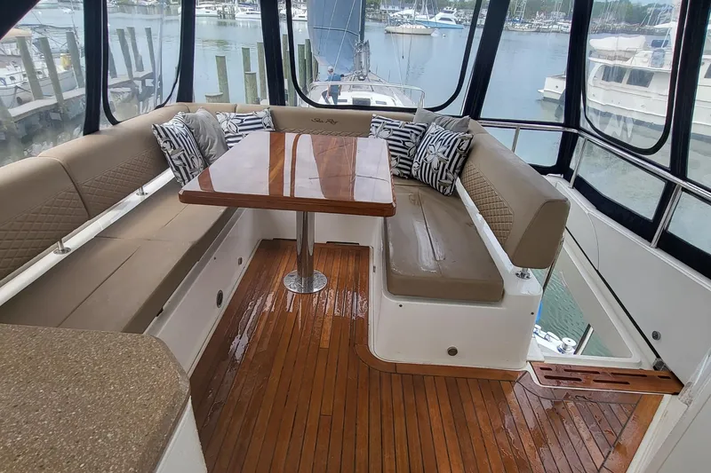 Slide: The Image of Luxurious 2018 Sea Ray L590 Fly yacht interior with elegant seating and wooden flooring. - 27