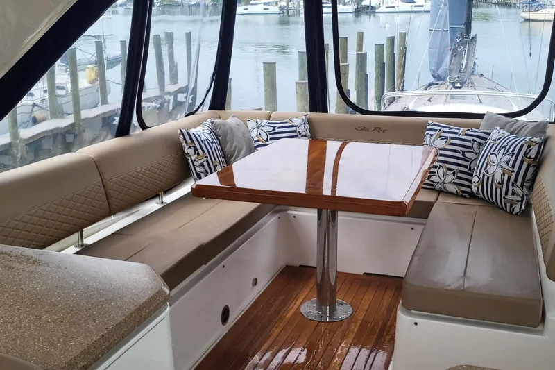 Slide: The Image of Luxurious interior of 2018 Sea Ray L590 Fly yacht with elegant seating and polished wood table. - 28
