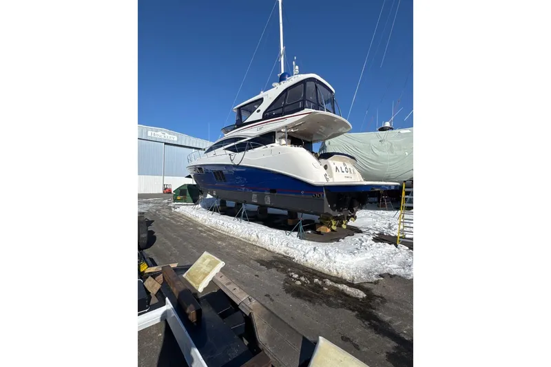 Slide: The Image of 2018 Sea Ray L590 Fly yacht on dry dock in snowy marina. - 3