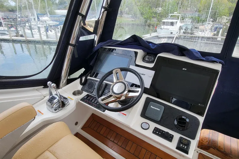 Slide: The Image of Helm of 2018 Sea Ray L590 Fly yacht with modern navigation equipment and controls. - 33