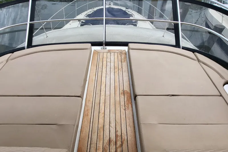 Slide: The Image of 2018 Sea Ray L590 Fly yacht with cushioned deck and wooden walkway. - 38
