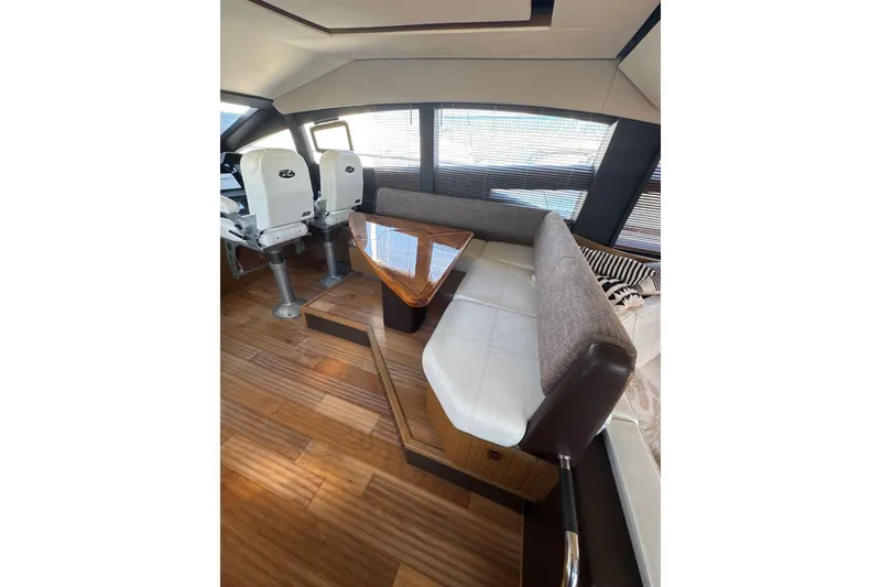 Slide: The Image of Luxurious interior of 2018 Sea Ray L590 Fly yacht with elegant seating and wooden flooring. - 4