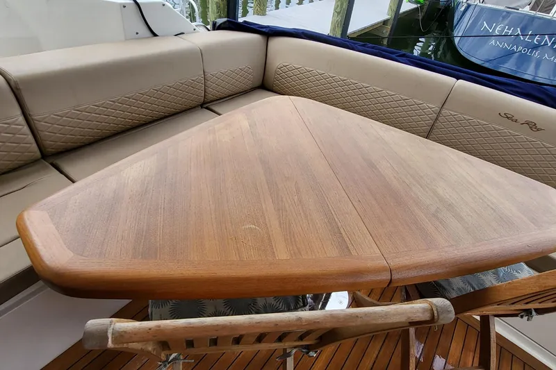 Slide: The Image of Luxurious seating area on 2018 Sea Ray L590 Fly yacht with wooden table. - 41