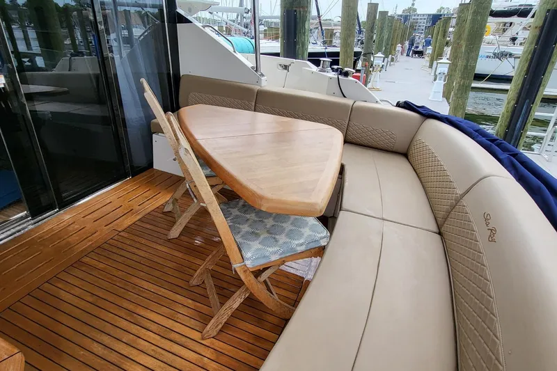 Slide: The Image of Luxurious 2018 Sea Ray L590 Fly yacht with elegant outdoor seating and wooden table. - 43