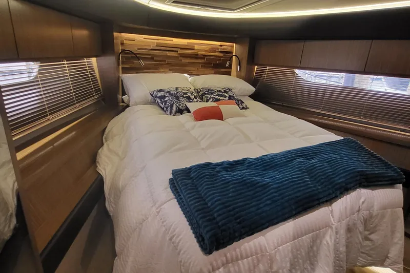 Slide: The Image of Luxurious bedroom interior of 2018 Sea Ray L590 Fly yacht with cozy bedding. - 46