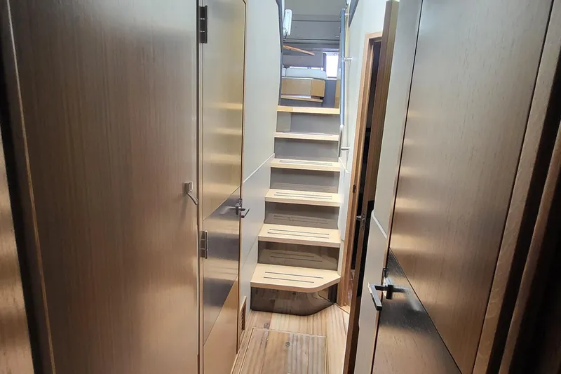 Slide: The Image of Interior hallway of 2018 Sea Ray L590 Fly yacht with wooden stairs and doors. - 50