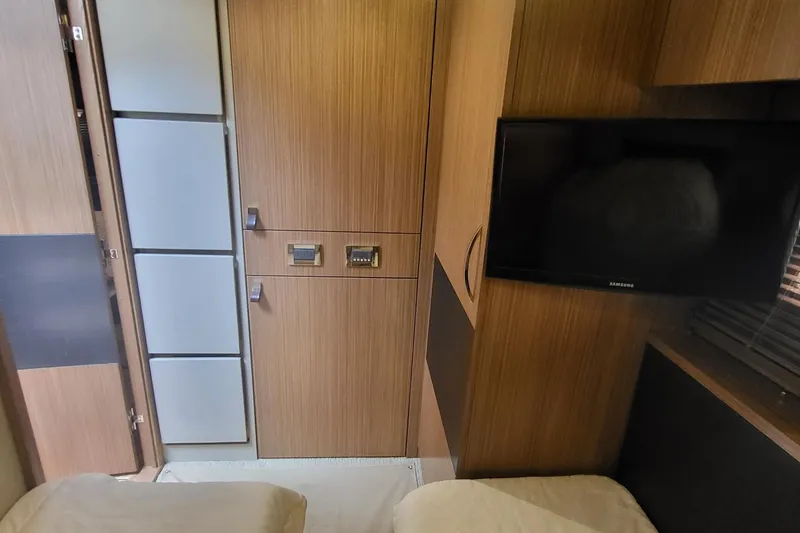Slide: The Image of Interior of 2018 Sea Ray L590 Fly yacht with wood paneling and mounted TV. - 52