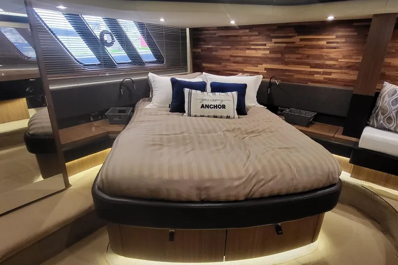 Slide: The Image of Luxurious 2018 Sea Ray L590 Fly yacht bedroom with elegant wood paneling and cozy bedding. - 56